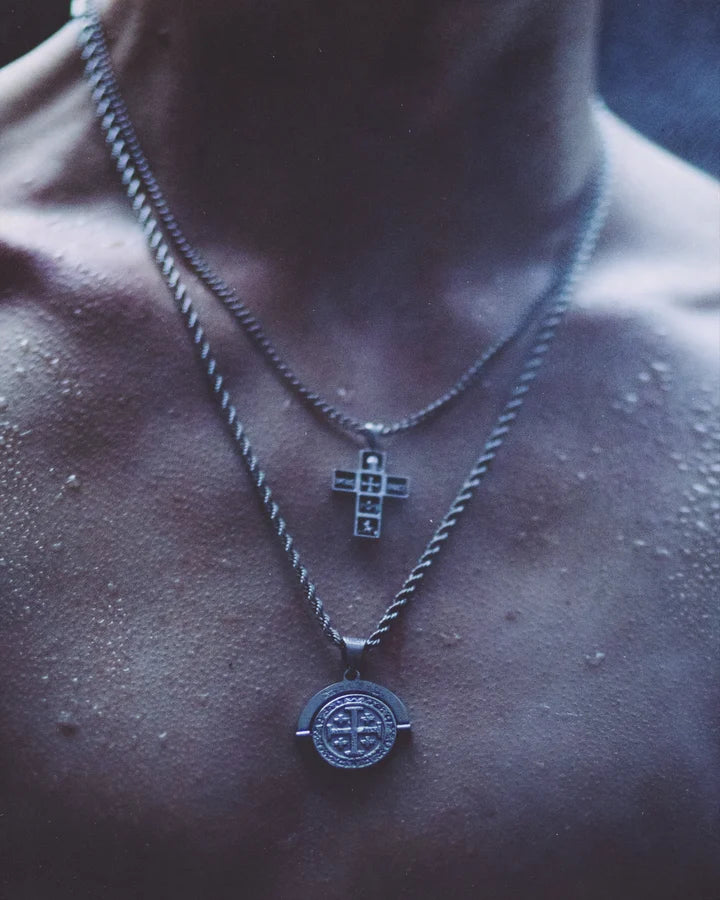 Deus Vult coin and cross pendants, worn close-up